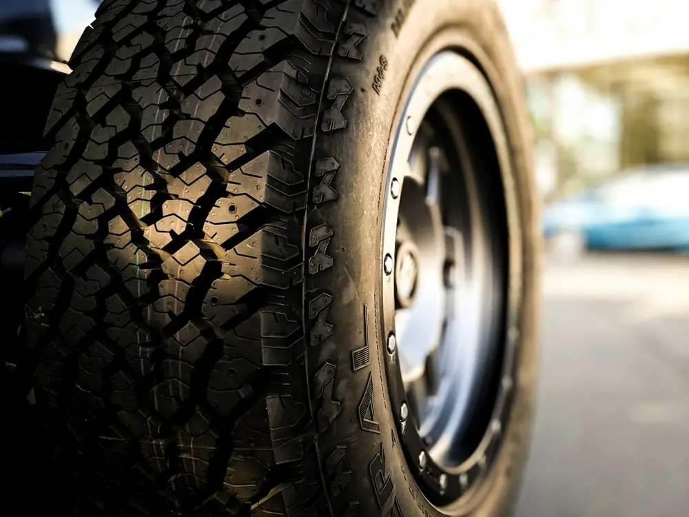 An all-terrain tire tread on a rugged truck