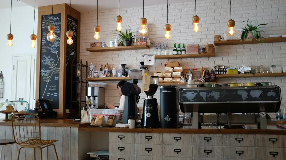 Espresso machine on a counter under pendant lights