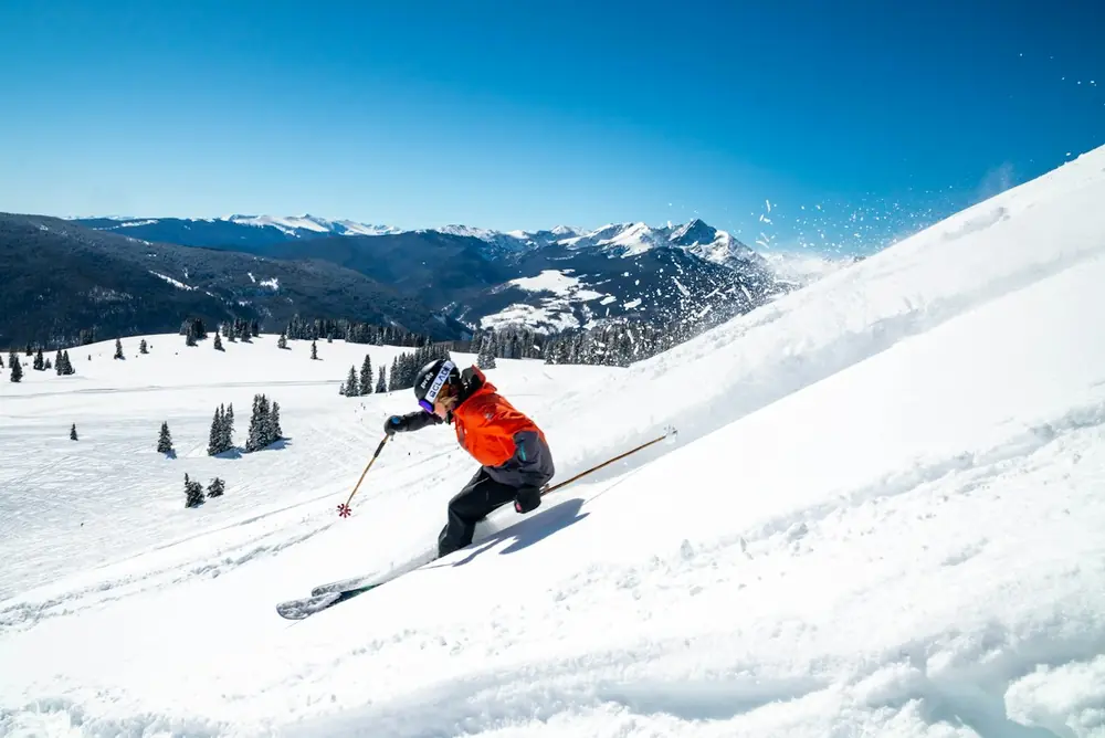 Ski tourers climbing a snowy ridge on skins